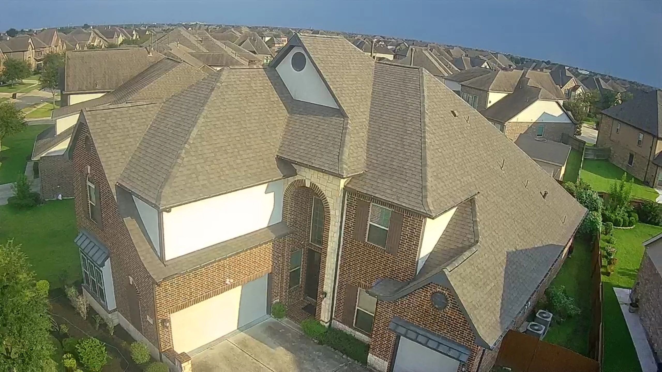 Multi-section residential roof on brick home