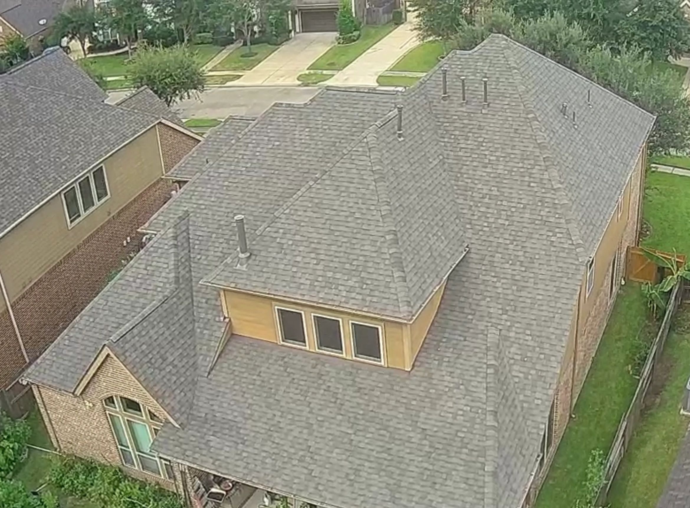 Completed gray shingle roof — aerial view
